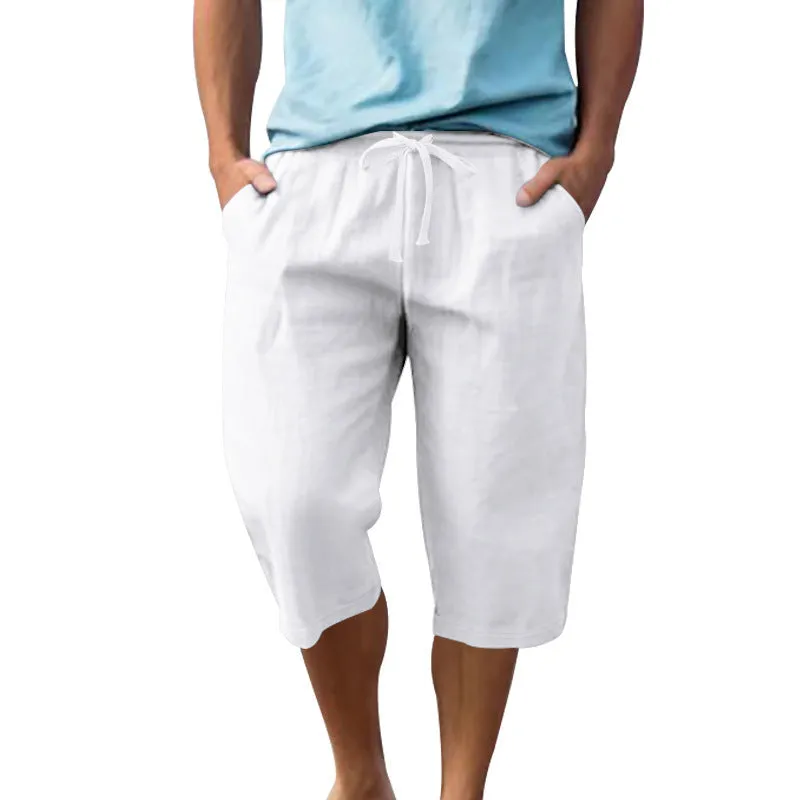 Men's light khaki linen shorts with a drawstring waistband and loose, cropped leg fit.