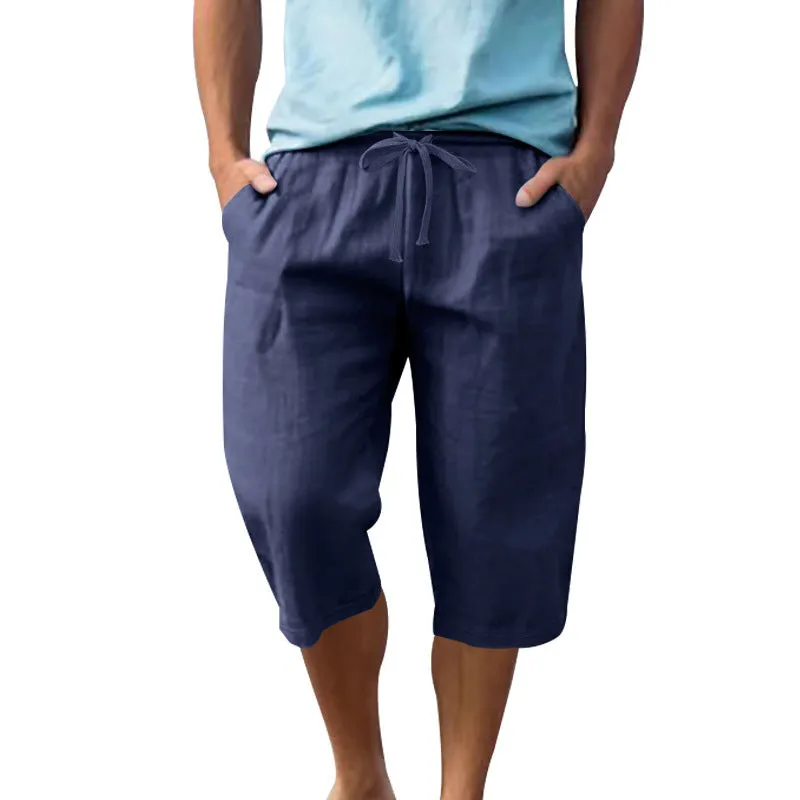 Men's light khaki linen shorts with a drawstring waistband and loose, cropped leg fit.