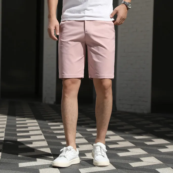 Man wearing loose-fit beige mid-length casual trousers with an elasticated waistband.