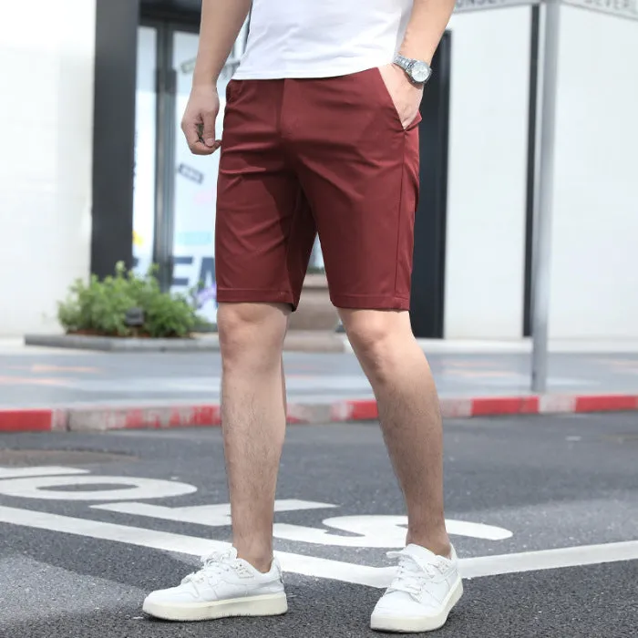 Man wearing loose-fit beige mid-length casual trousers with an elasticated waistband.