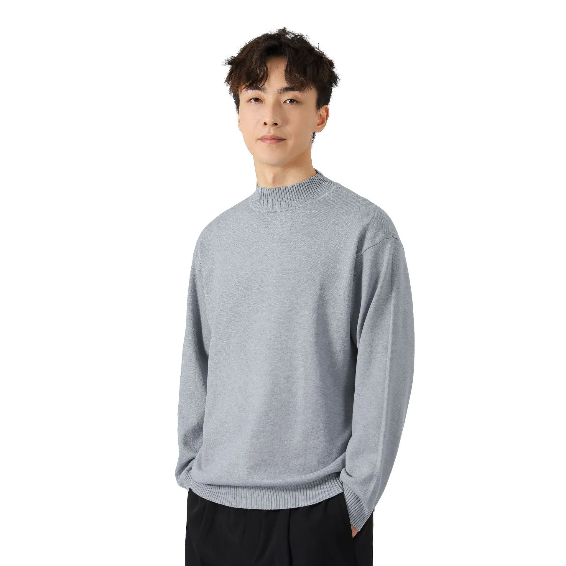 A man's loose-fitting, long-sleeve pullover sweater in a solid colour, showing a casual relaxed fit.