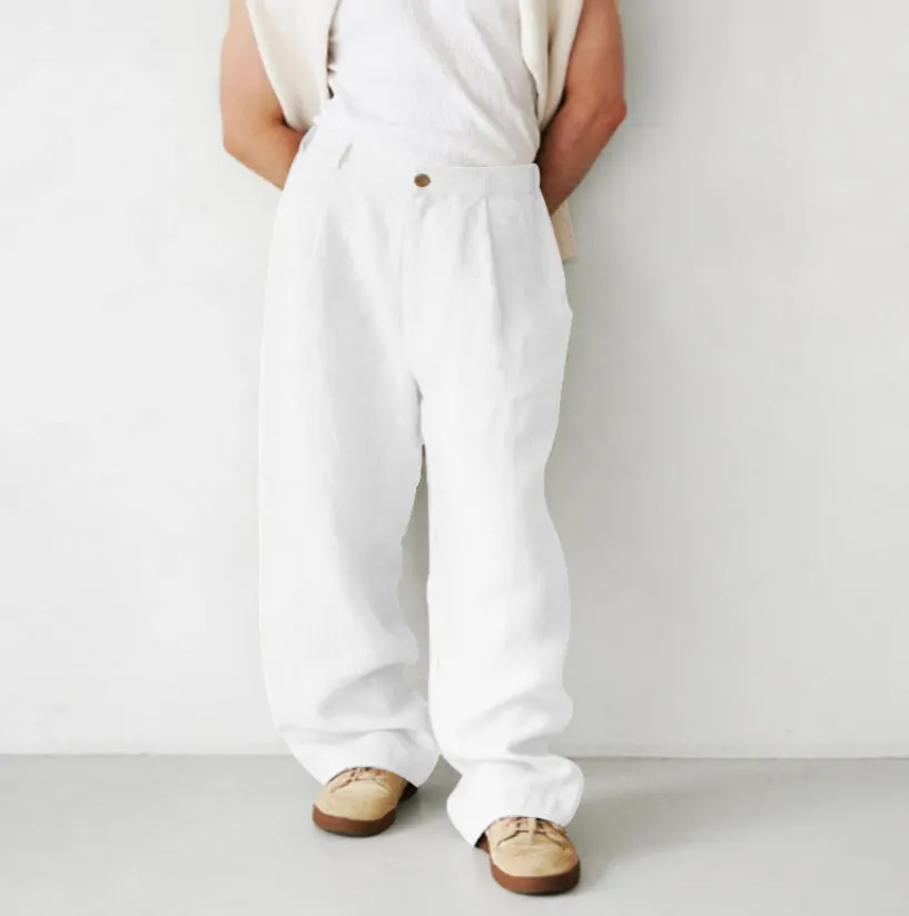 Man wearing loose grey linen high waist jogger pants with elasticated waistband.