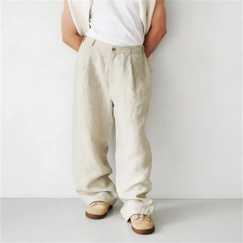 Man wearing loose grey linen high waist jogger pants with elasticated waistband.