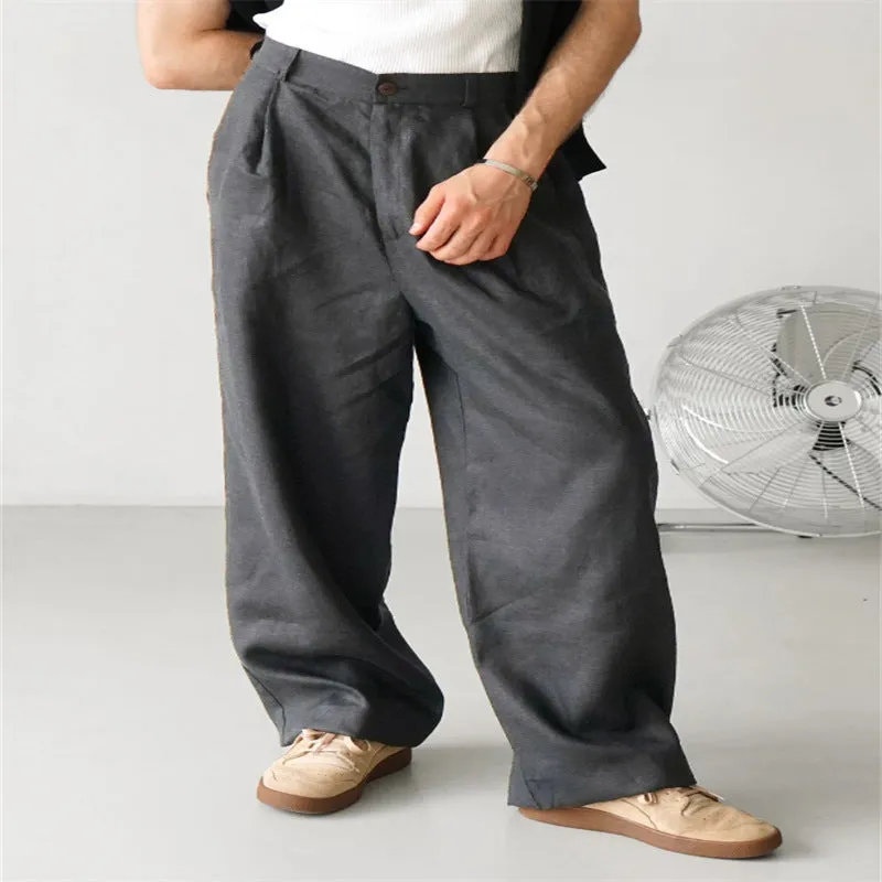 Man wearing loose grey linen high waist jogger pants with elasticated waistband.