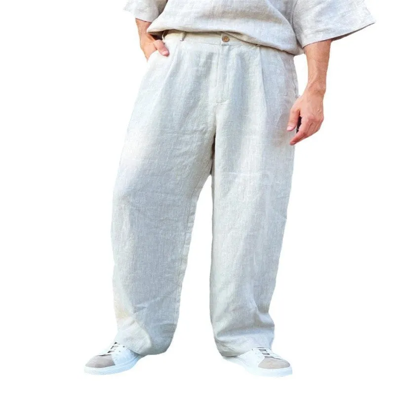 Man wearing loose grey linen high waist jogger pants with elasticated waistband.