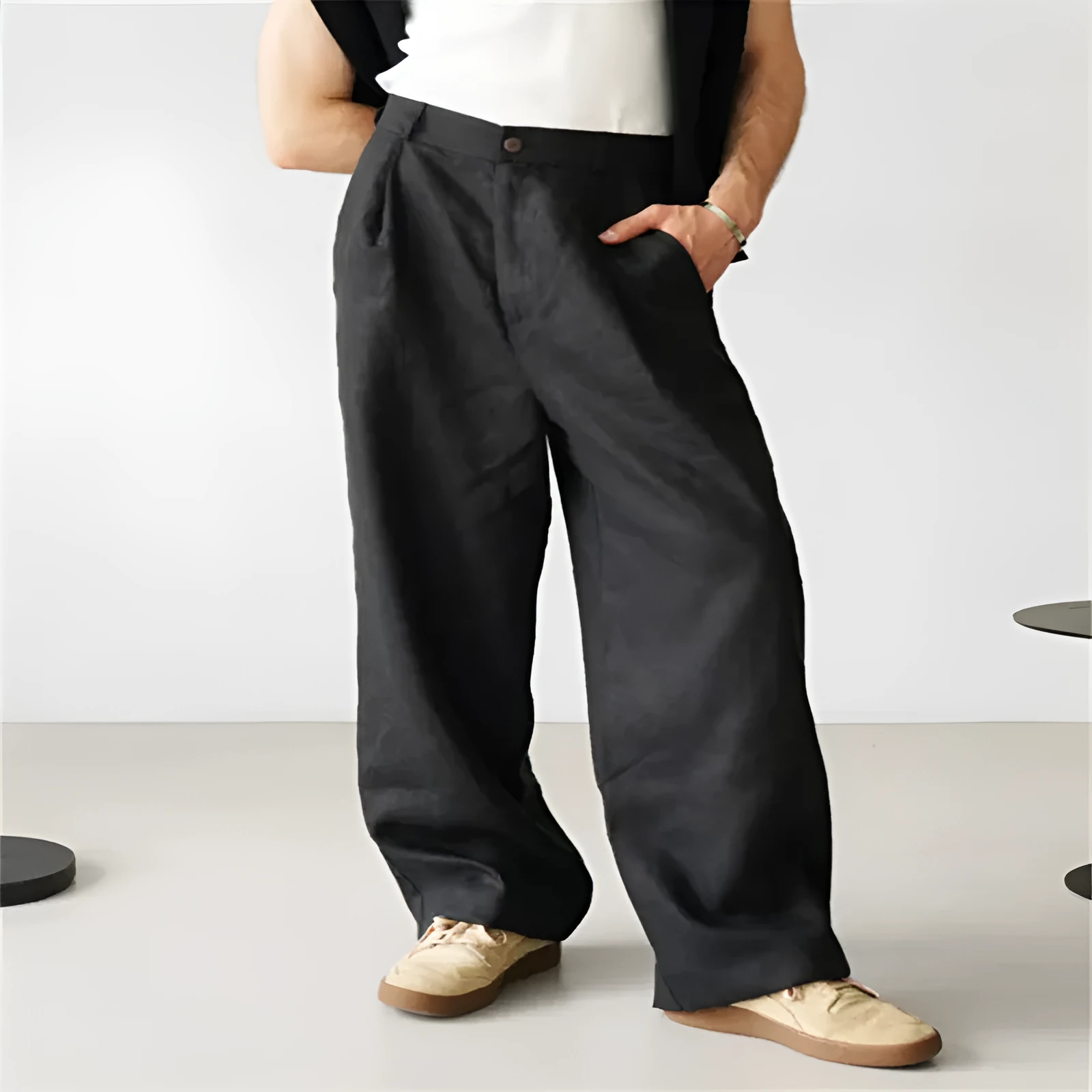 Man wearing loose grey linen high waist jogger pants with elasticated waistband.