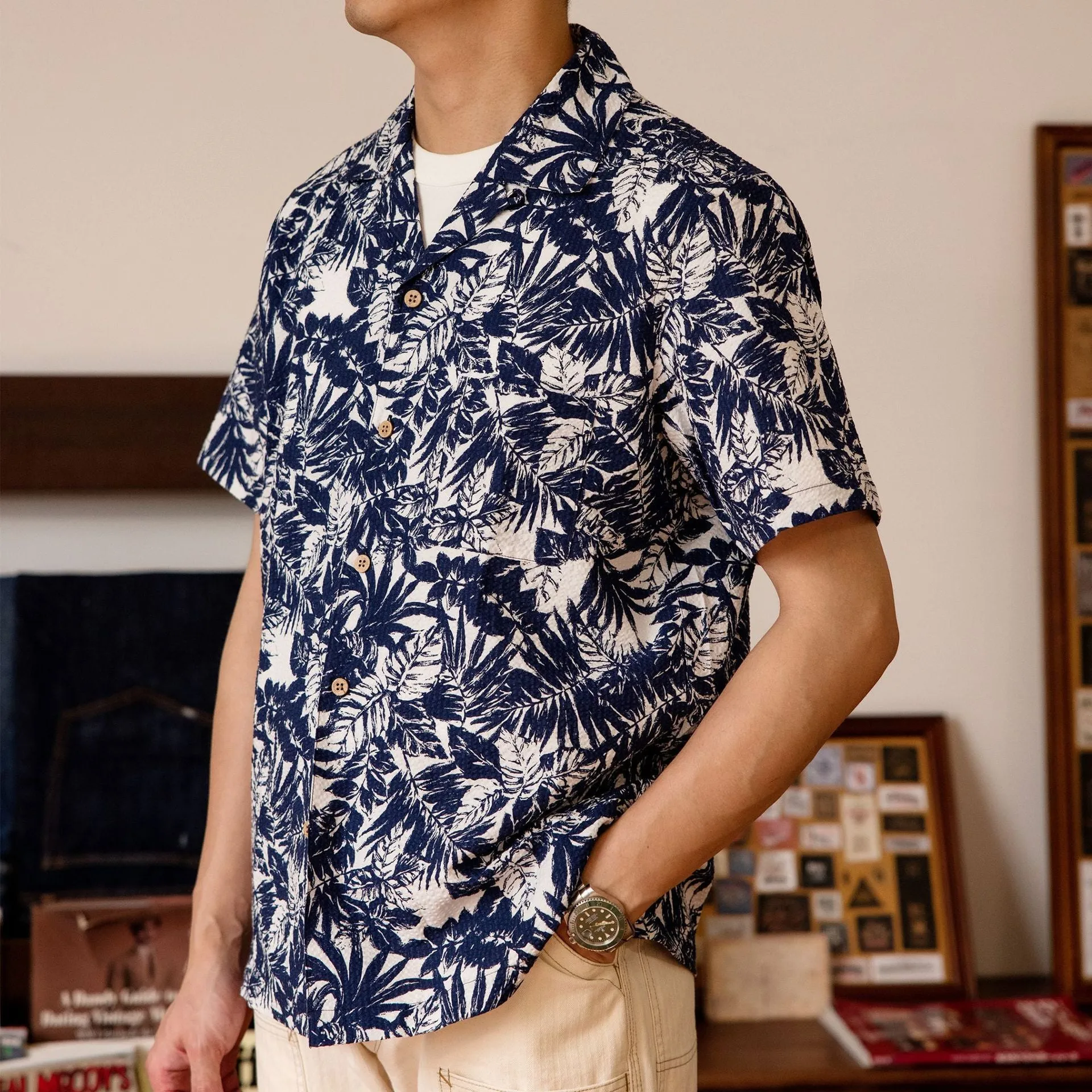 Vintage floral print seersucker shirt with a Cuban collar on a mannequin, showing loose cardigan fit.