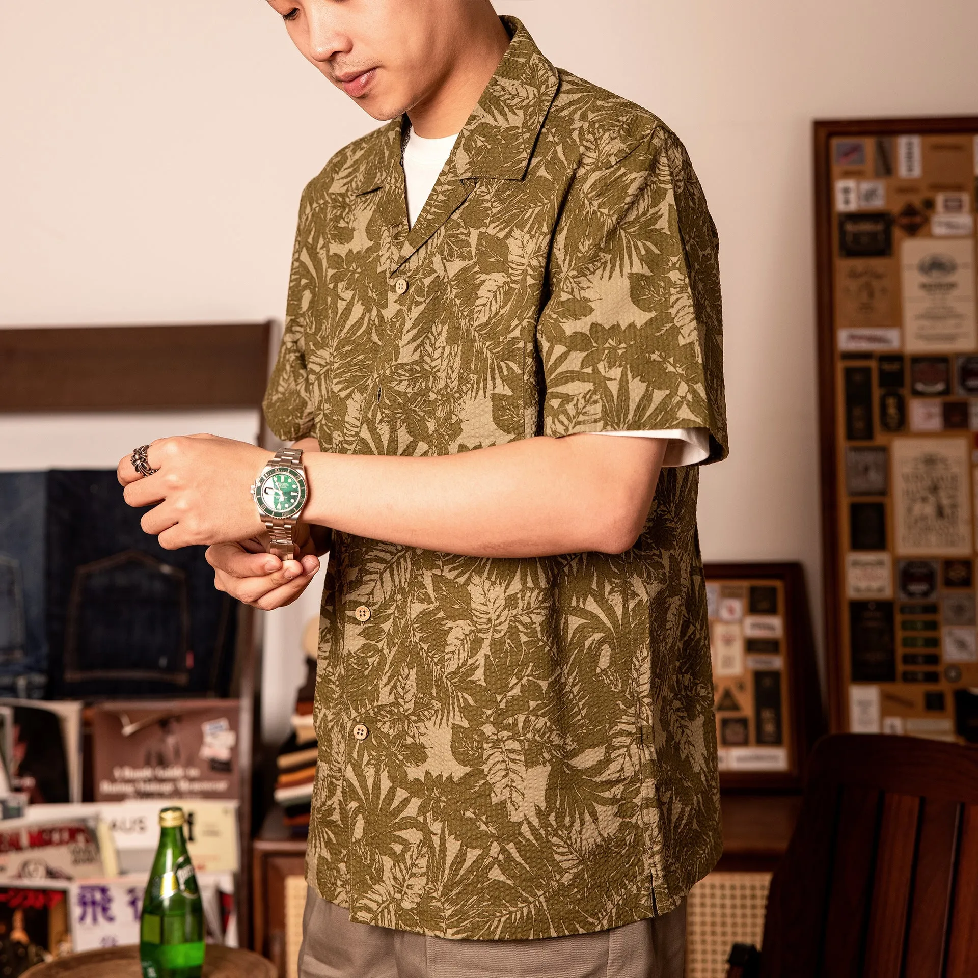 Vintage floral print seersucker shirt with a Cuban collar on a mannequin, showing loose cardigan fit.