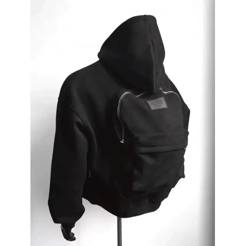 Man wearing a light gray hooded coat with a schoolbag design detail on the back.