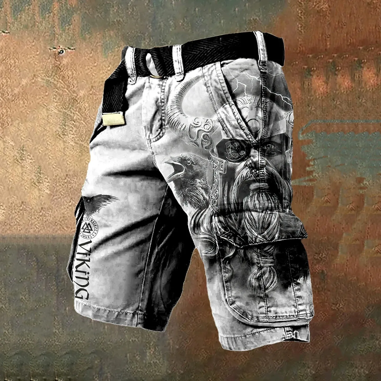 Man wearing grey shorts with a graphic 3D print and a full-length zip fastening.