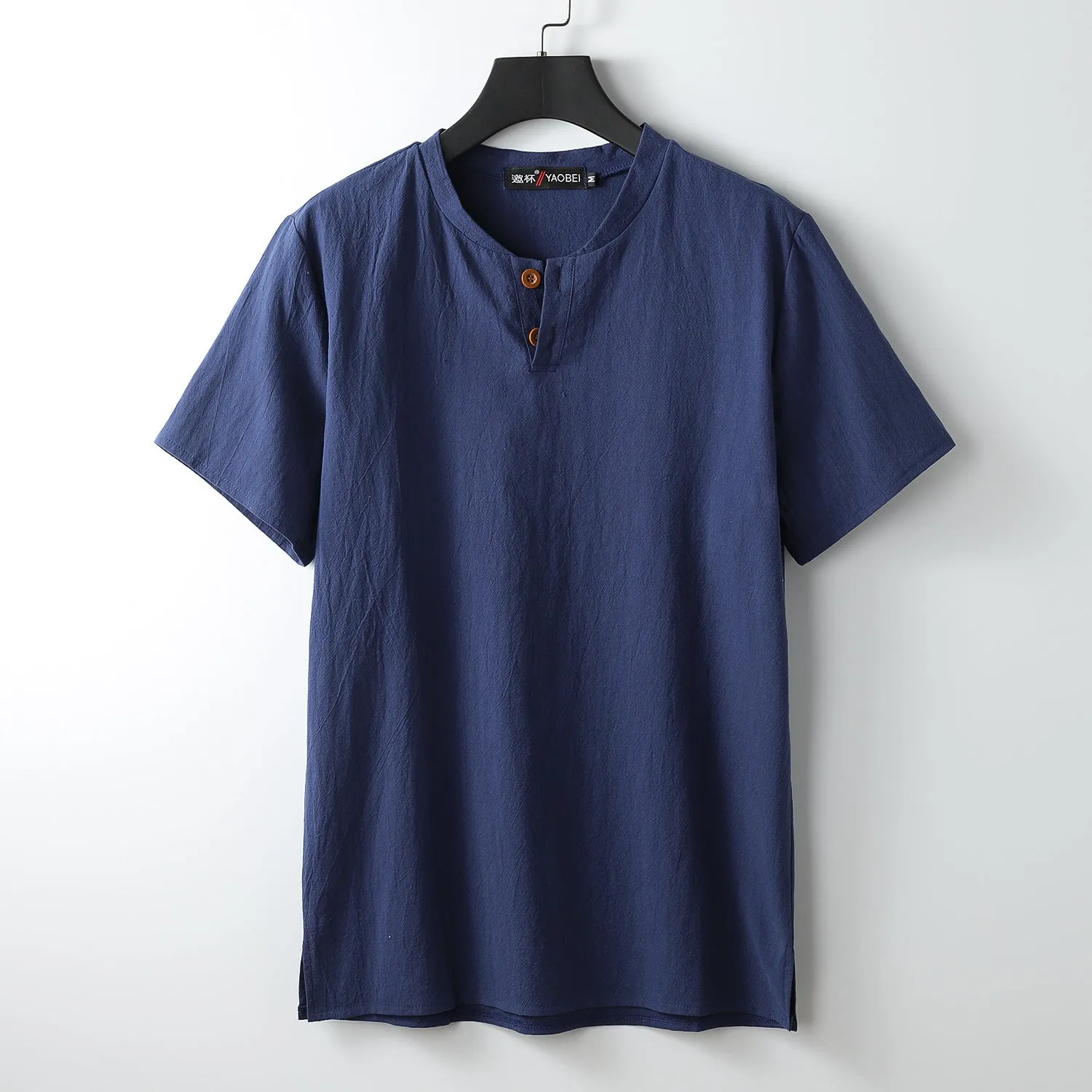 Women's loose-fit apricot coloured V-neck short sleeve cotton top on a hanger.