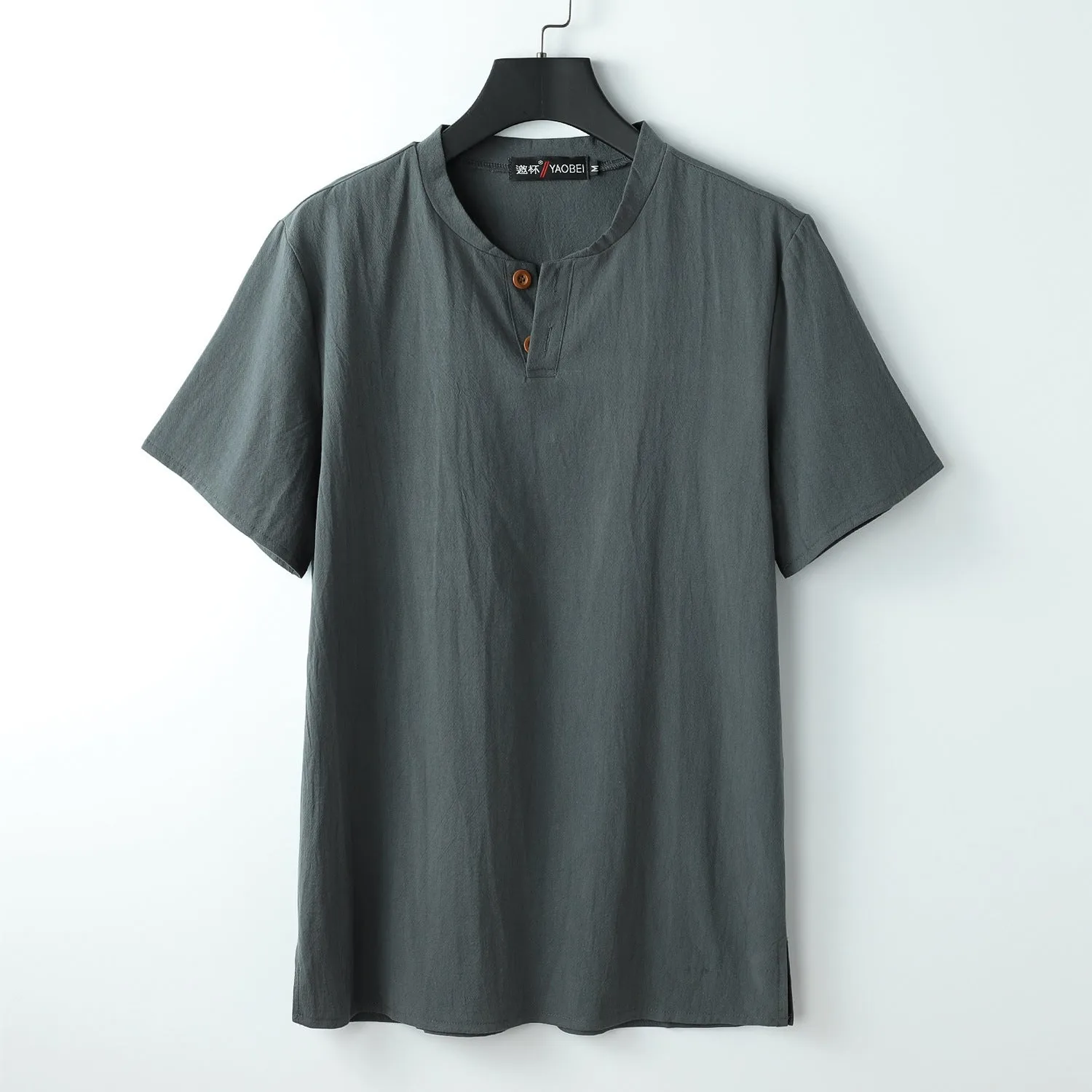 Women's loose-fit apricot coloured V-neck short sleeve cotton top on a hanger.