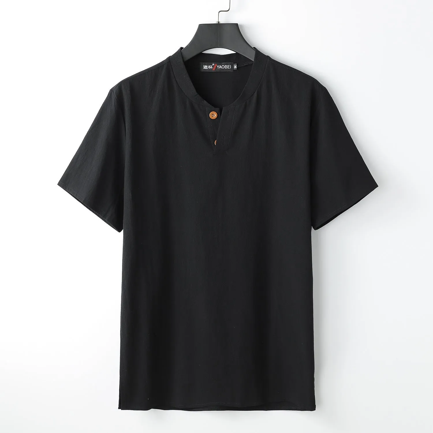 Women's loose-fit apricot coloured V-neck short sleeve cotton top on a hanger.