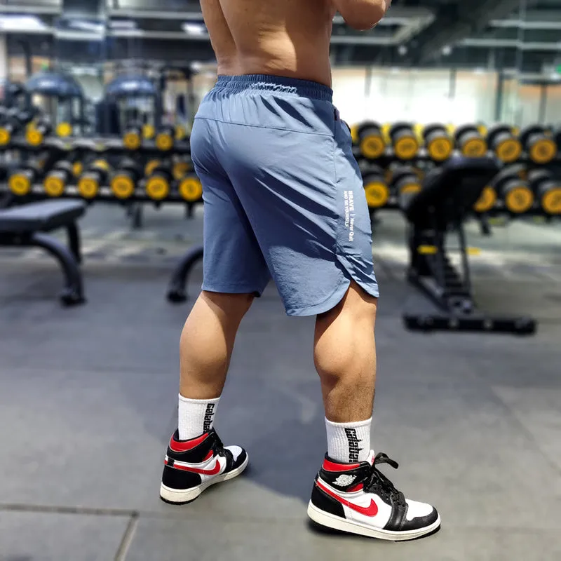 Men's black quick-drying thin running shorts made of nylon and spandex blend on a grey background.