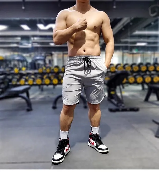 Men's black quick-drying thin running shorts made of nylon and spandex blend on a grey background.