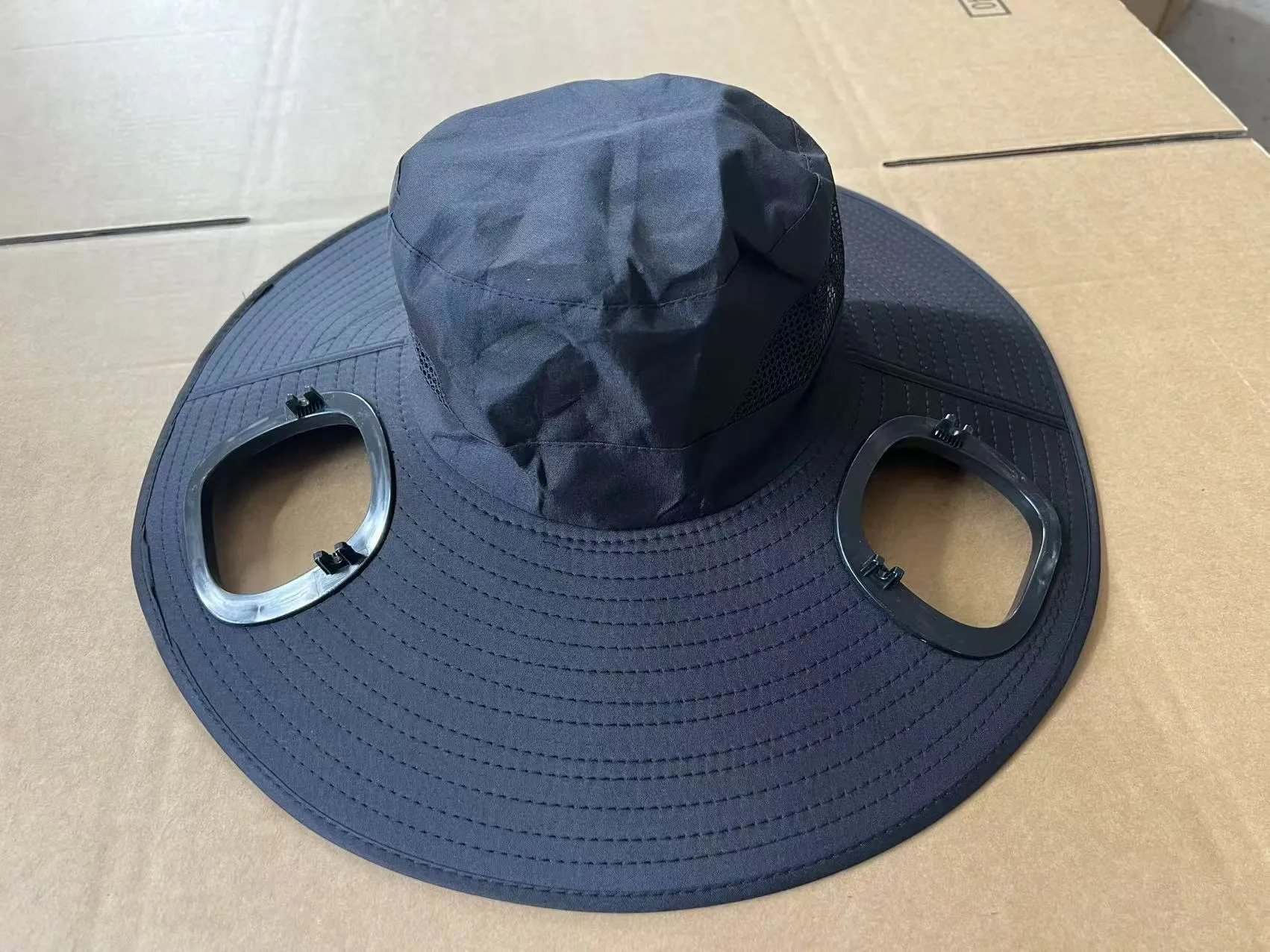 Grey solar-powered ventilation cap with large brim and built-in fan on the front.