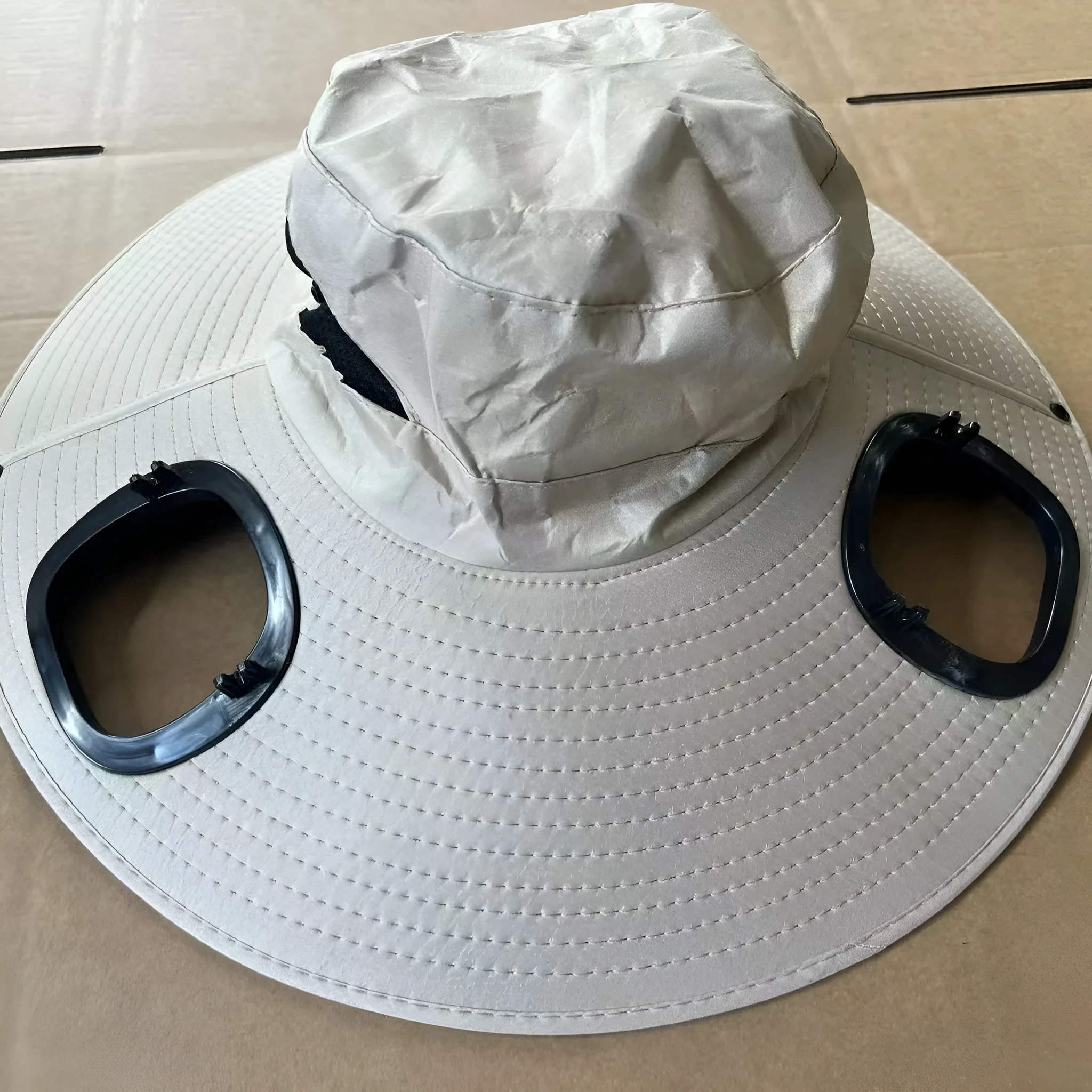 Grey solar-powered ventilation cap with large brim and built-in fan on the front.