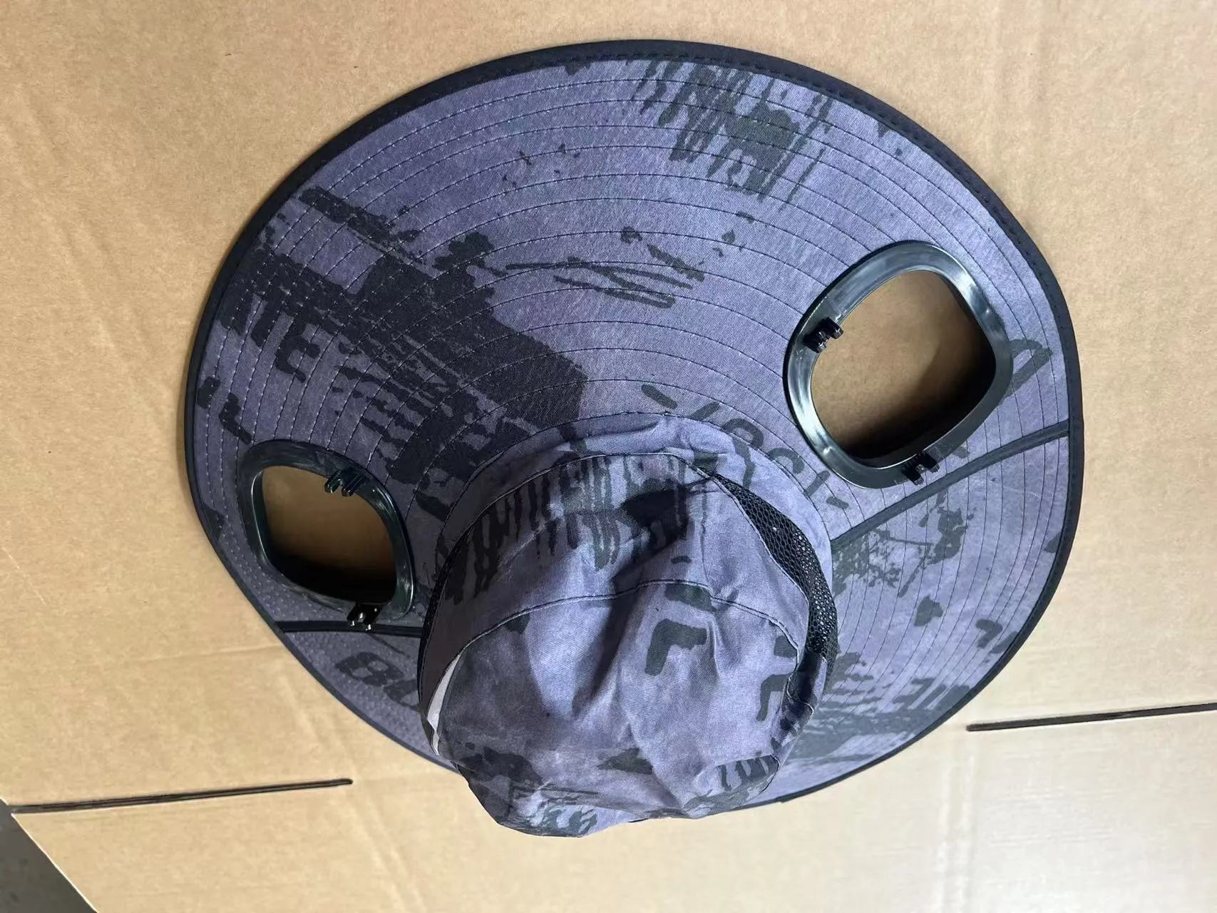 Grey solar-powered ventilation cap with large brim and built-in fan on the front.
