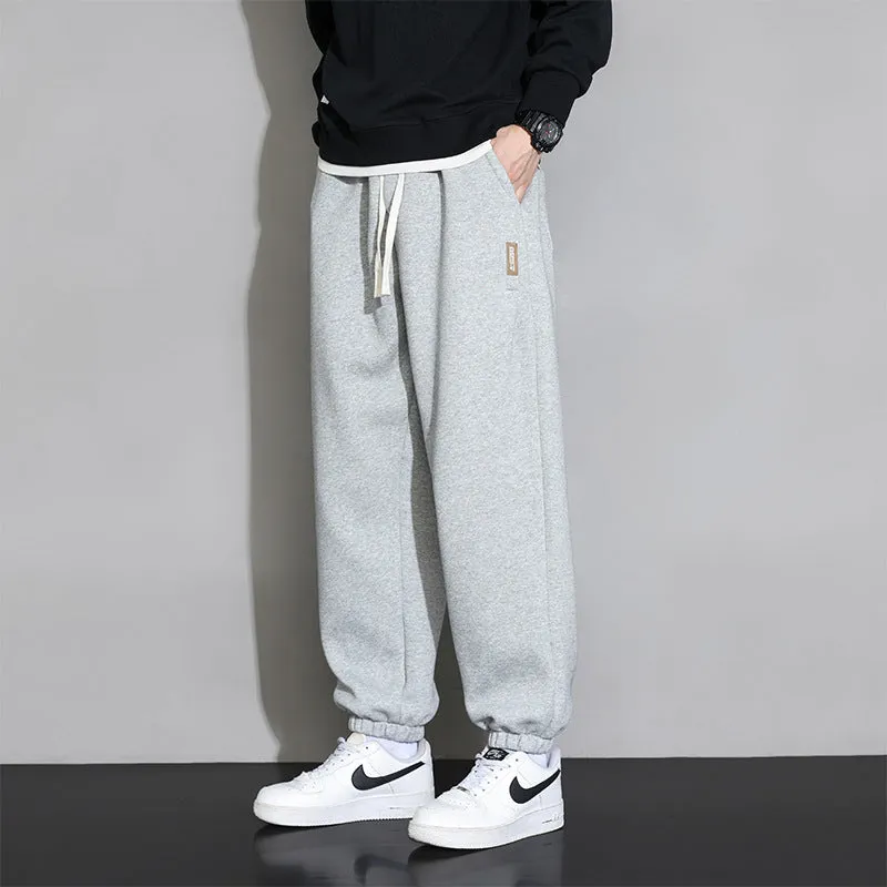 Men's loose grey sports trousers with drawstring waist in cotton-polyester blend