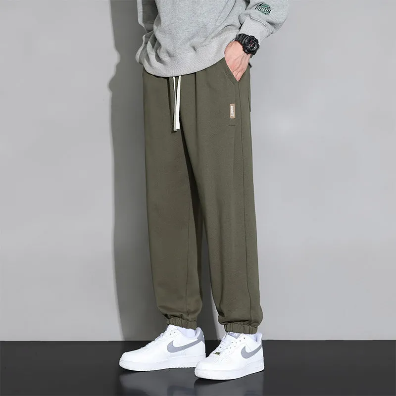 Men's loose grey sports trousers with drawstring waist in cotton-polyester blend