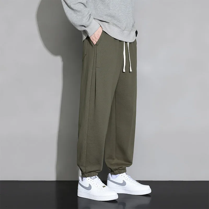 Men's loose grey sports trousers with drawstring waist in cotton-polyester blend