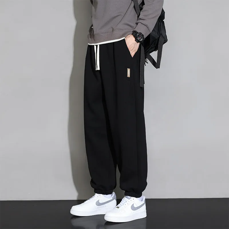 Men's loose grey sports trousers with drawstring waist in cotton-polyester blend
