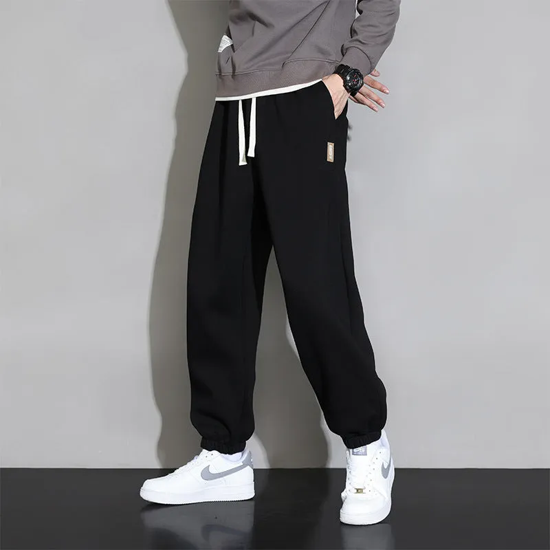Men's loose grey sports trousers with drawstring waist in cotton-polyester blend