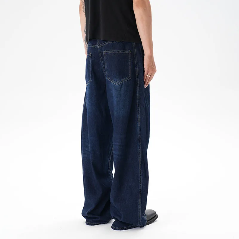 Dark blue washed distressed wide leg machete jeans on a model, showing the denim fabric and relaxed fit.
