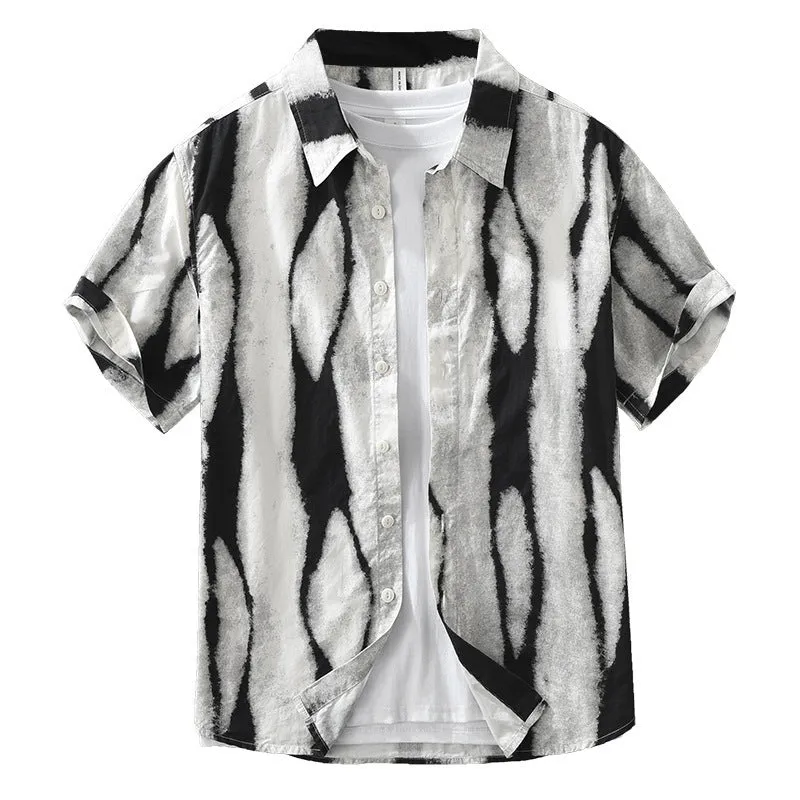 A man wearing a black and white striped loose-fit cotton cardigan-style short sleeve shirt.