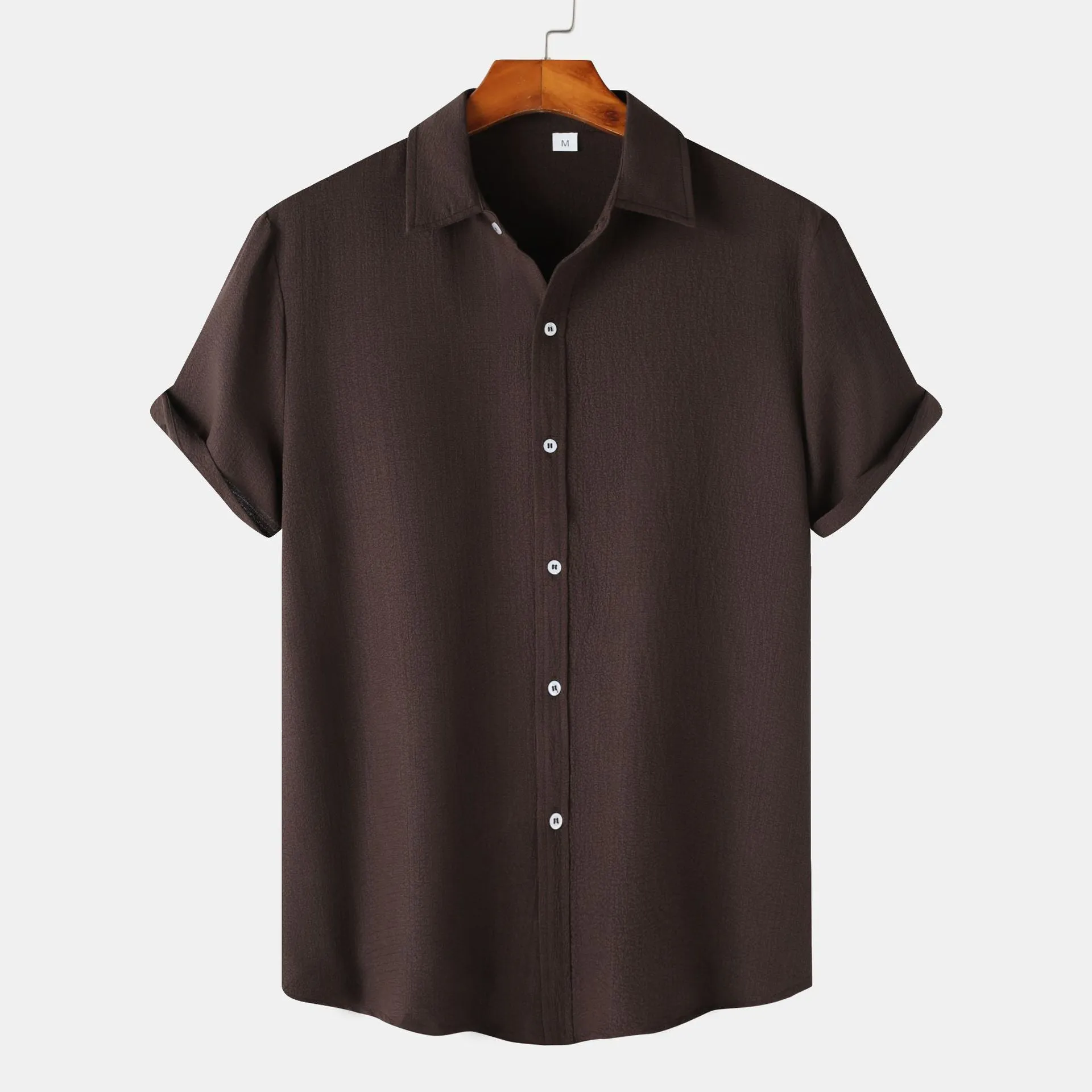 Men's casual short-sleeved polyester shirt in cardigan style on a hanger