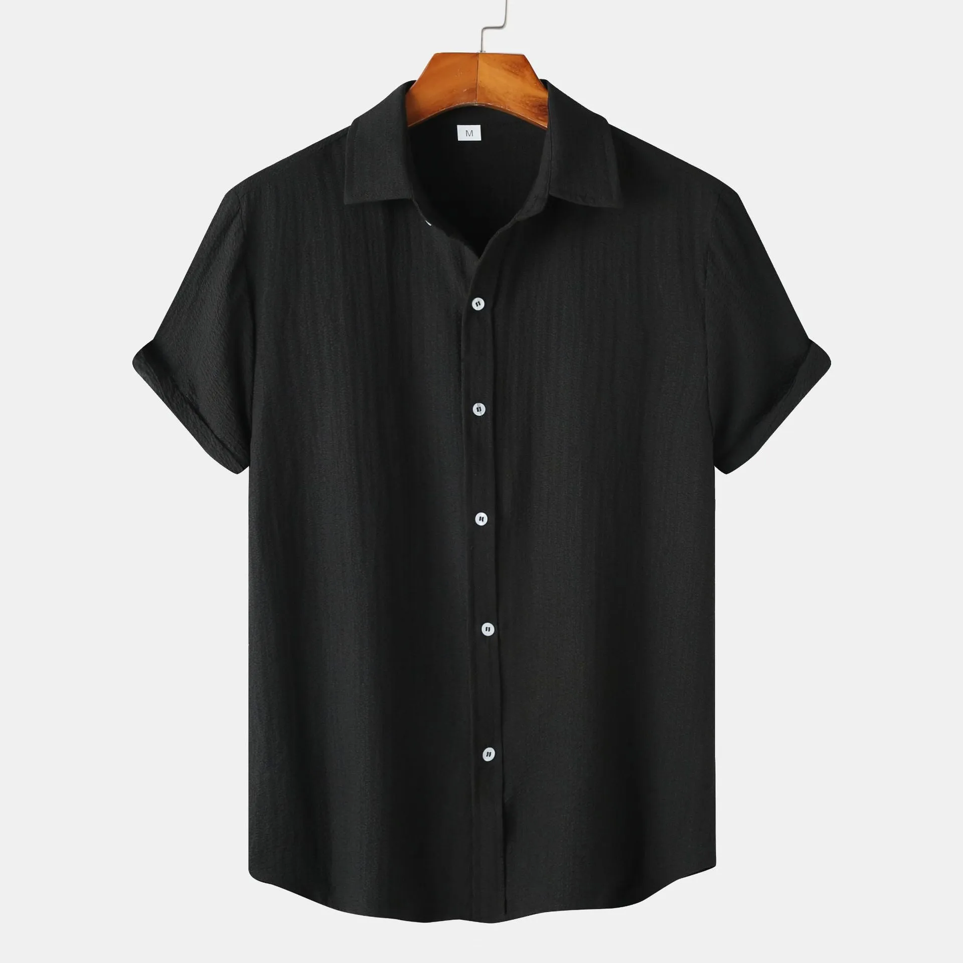 Men's casual short-sleeved polyester shirt in cardigan style on a hanger