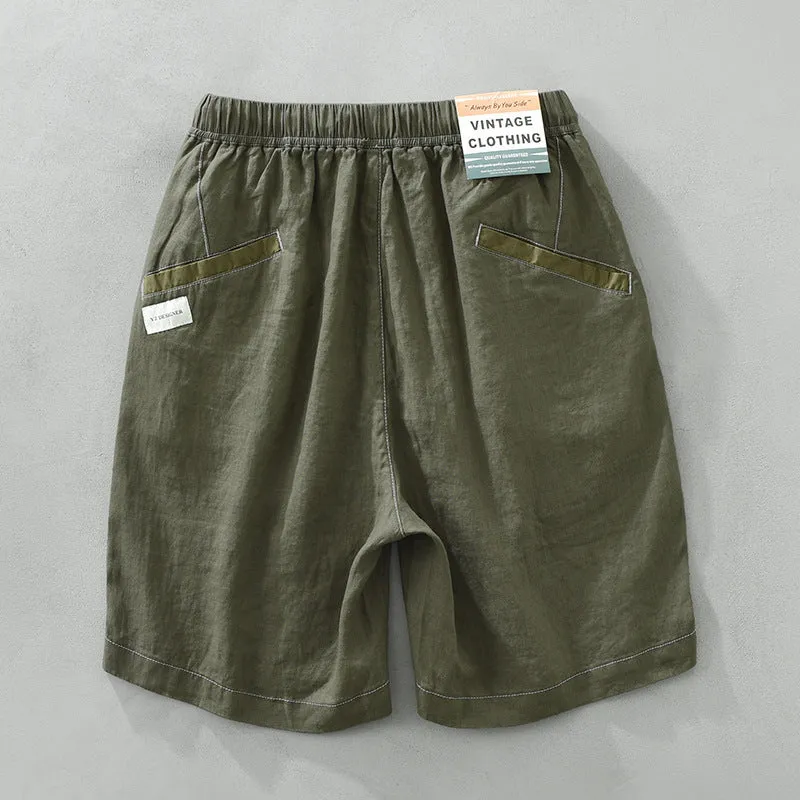 Men's loose straight leg linen shorts in green with drawstring waist and mid thigh length