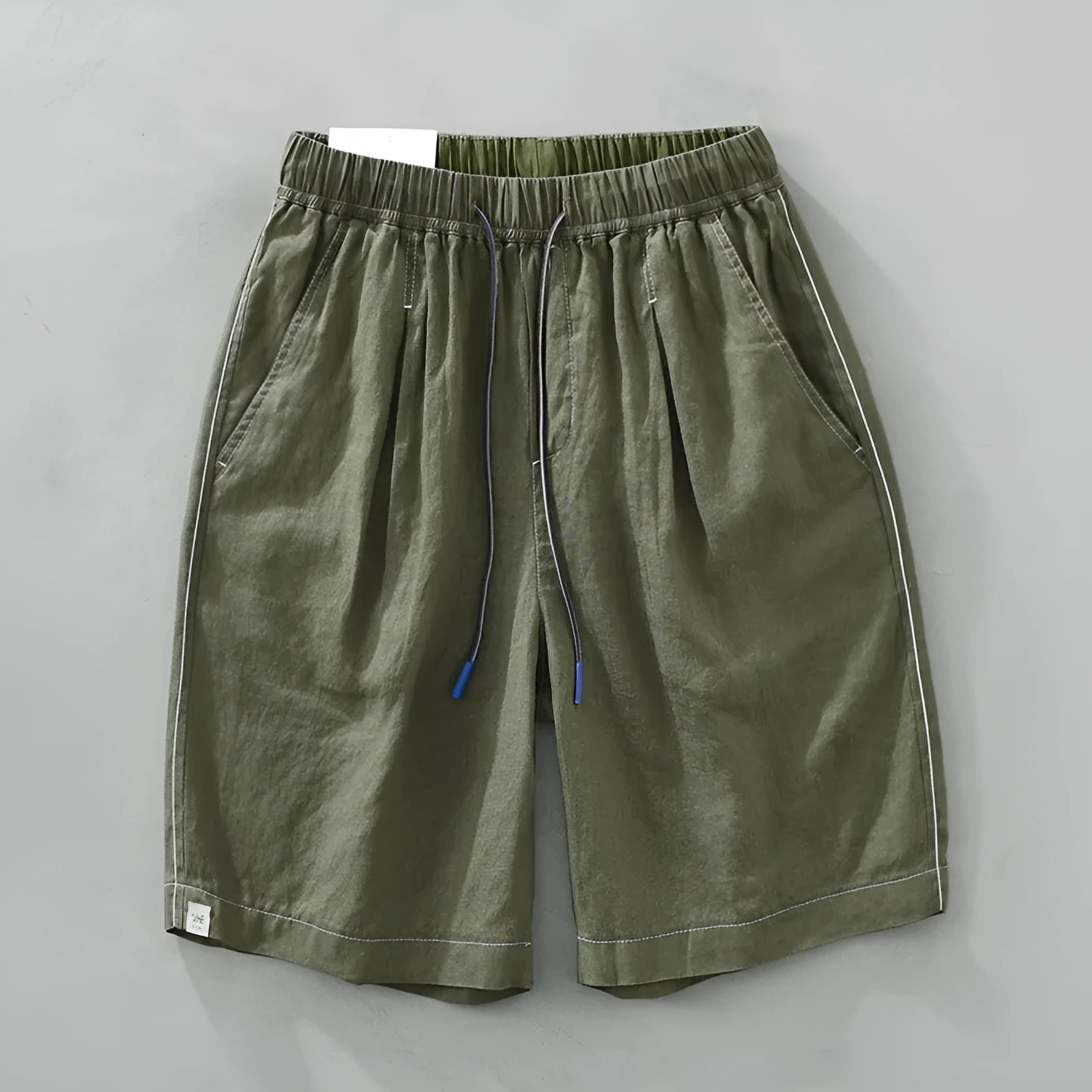 Men's loose straight leg linen shorts in green with drawstring waist and mid thigh length