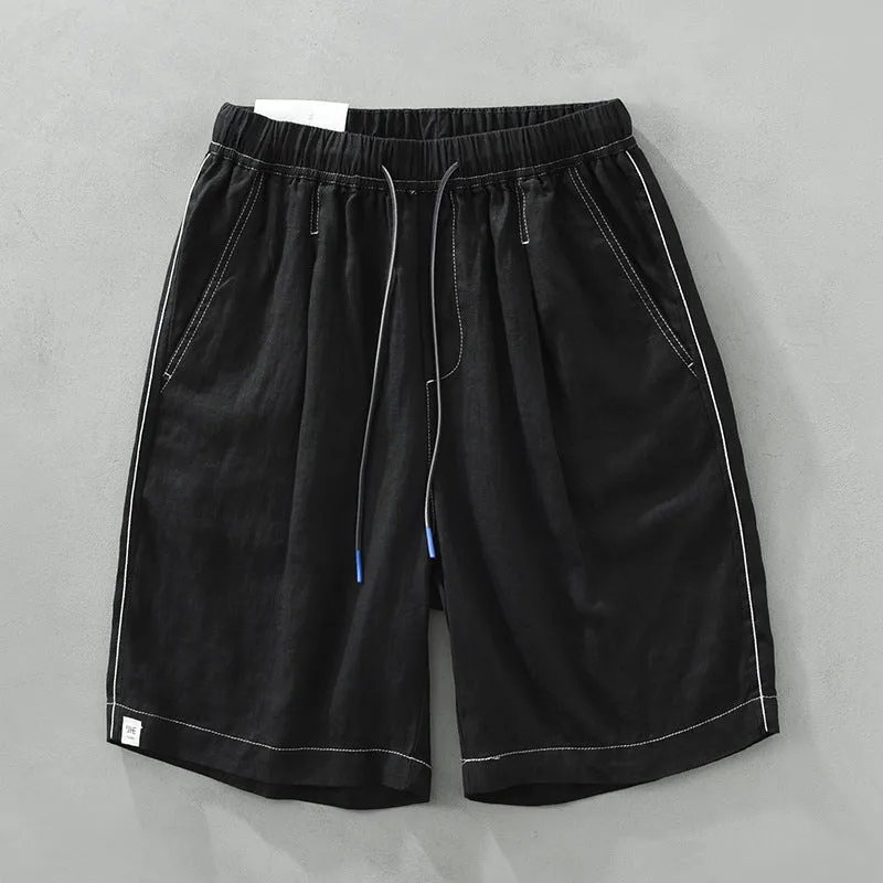Men's loose straight leg linen shorts in green with drawstring waist and mid thigh length