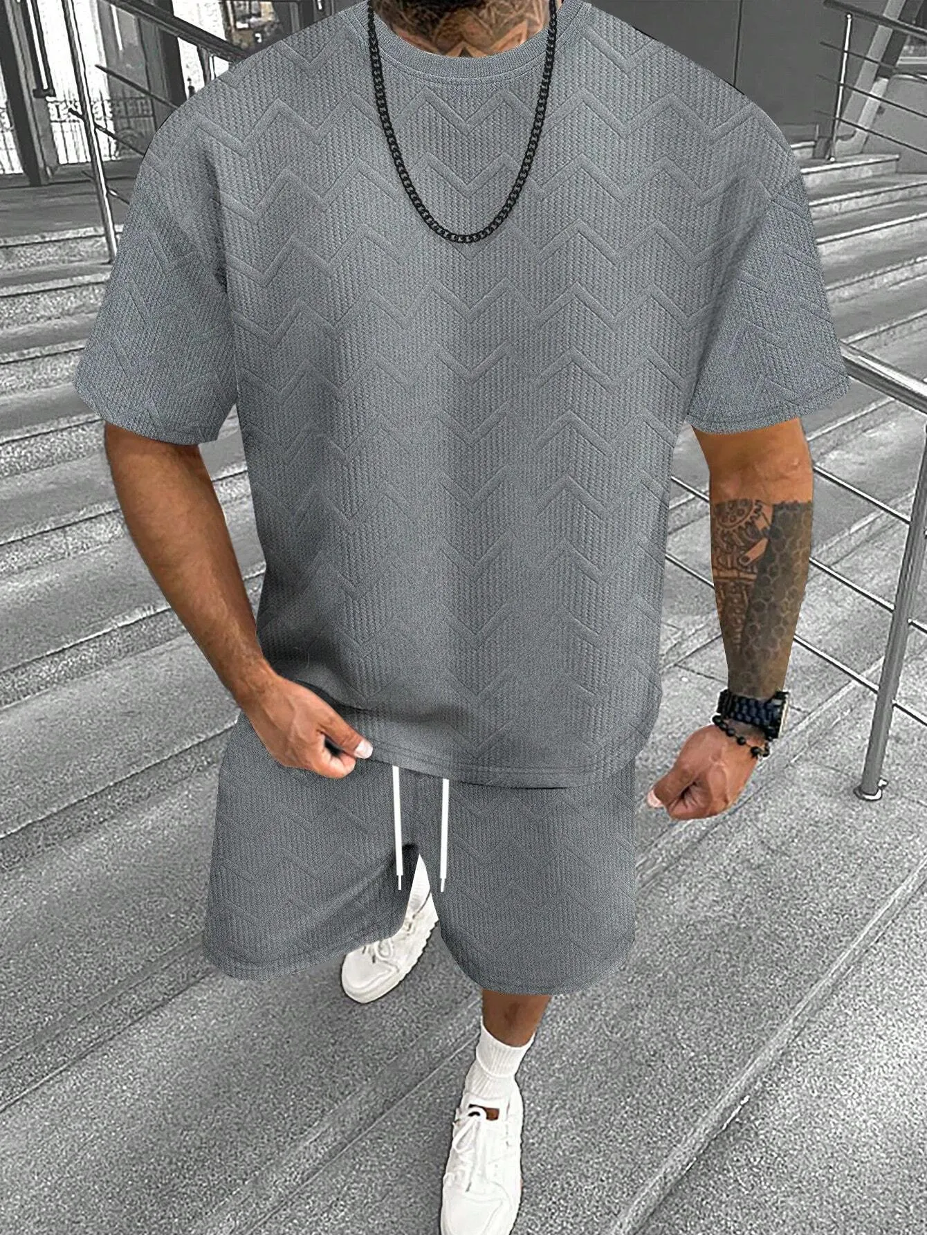 Men's grey short sleeve top and matching shorts suit set for casual leisure wear.