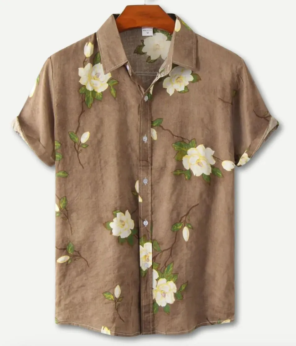 Man's short sleeve Hawaiian print shirt with lapel collar and floral pattern, shown in a casual setting.