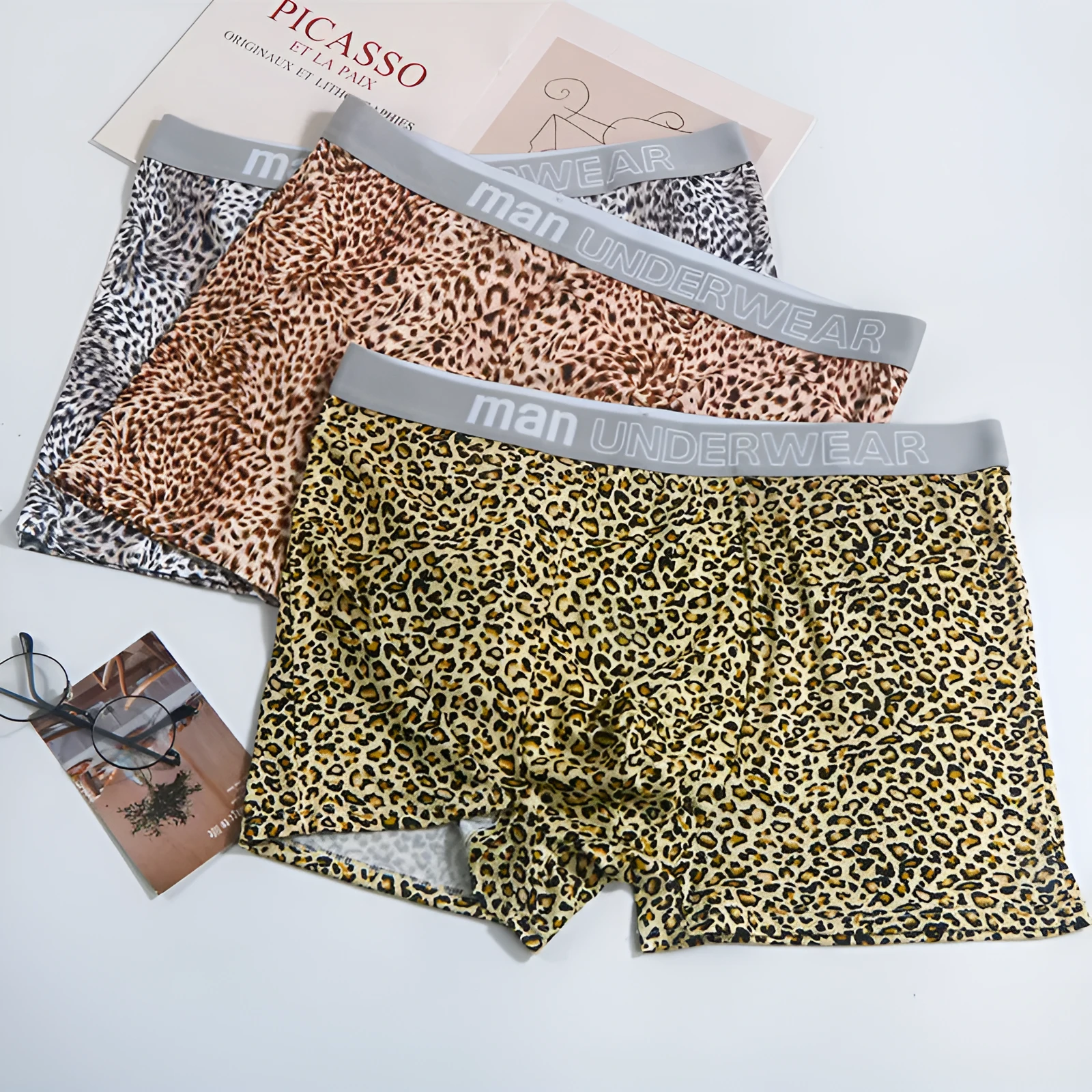 Men's loose fit leopard print underwear in milk silk polyester fabric showing mid-waist design