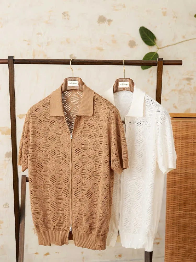 Light brown short sleeve cotton cardigan with a front zipper and lapel collar laid flat.