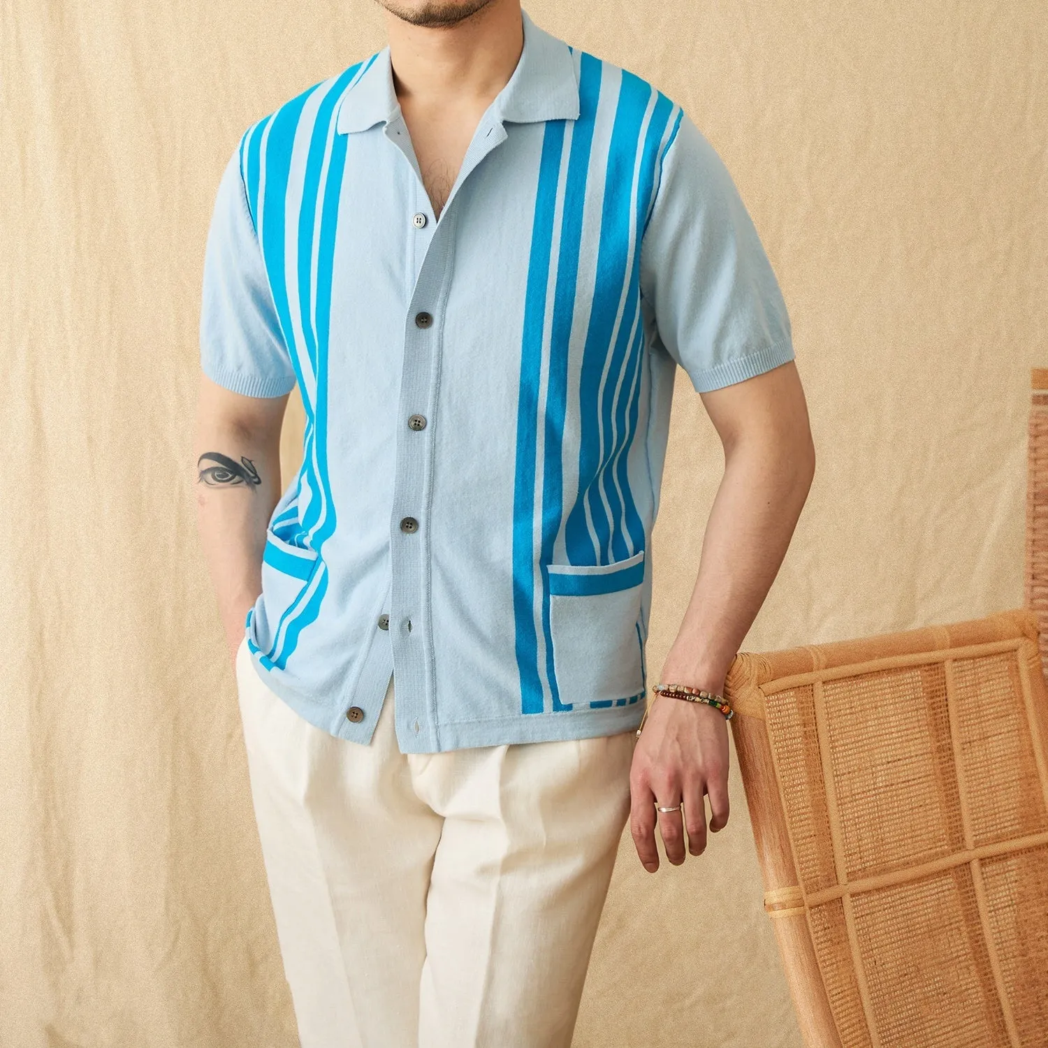 Man's short-sleeved striped polo cardigan with a lapel collar in a light blue colour.