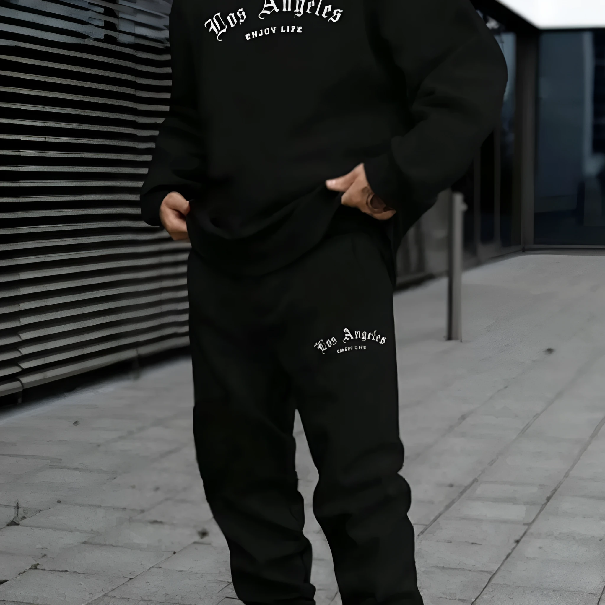 Men's grey hooded pullover sweater and matching trousers set on a hanger.
