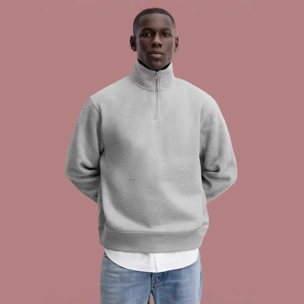 Grey half zip stand collar cotton sweater for men and women on a hanger.