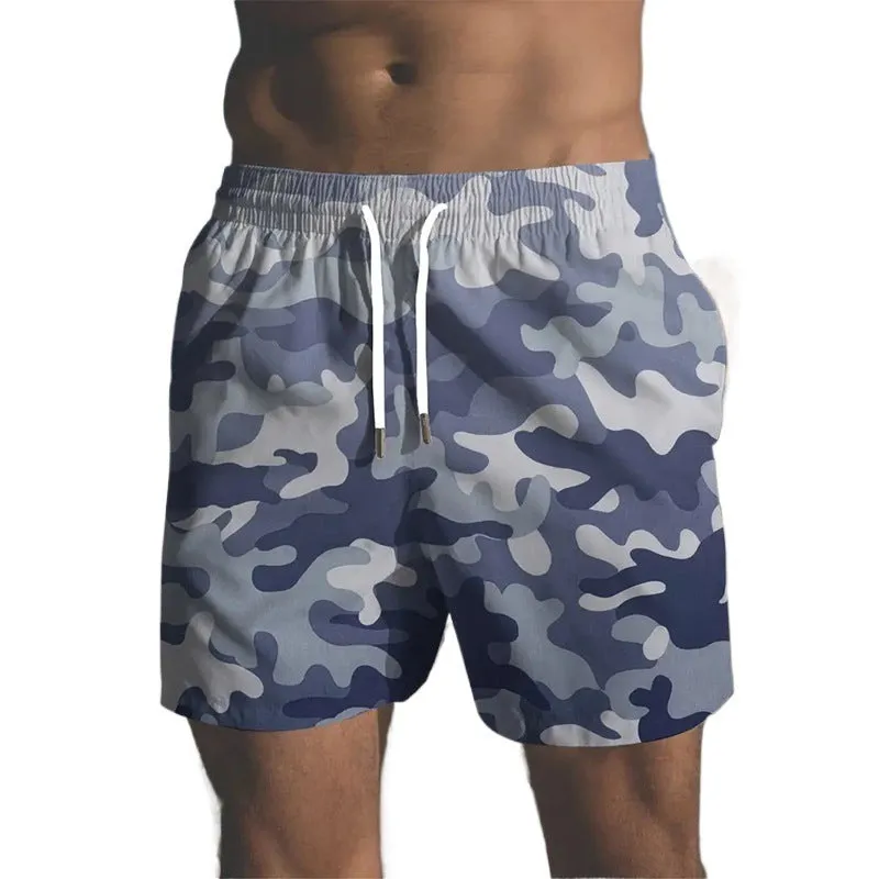 Men's printed polyester beach shorts on a model, showing elastic waistband and casual fit.