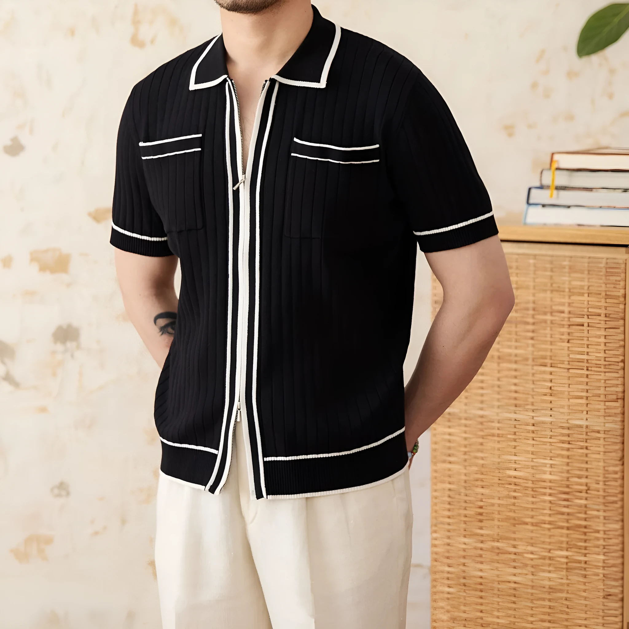 Slim fit black knitted polo shirt with a lapel collar and short sleeves on a hanger.