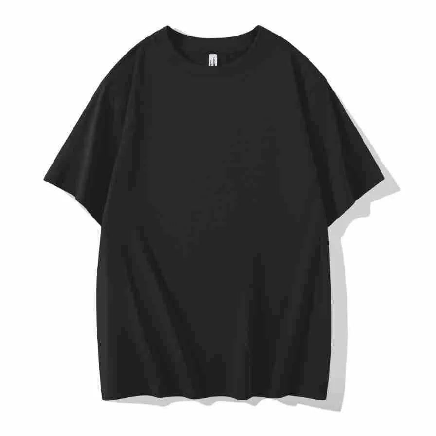 Man wearing a heavyweight dark grey drop shoulder T-shirt with layered shoulder detail.