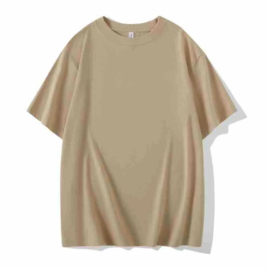 Man wearing a heavyweight dark grey drop shoulder T-shirt with layered shoulder detail.
