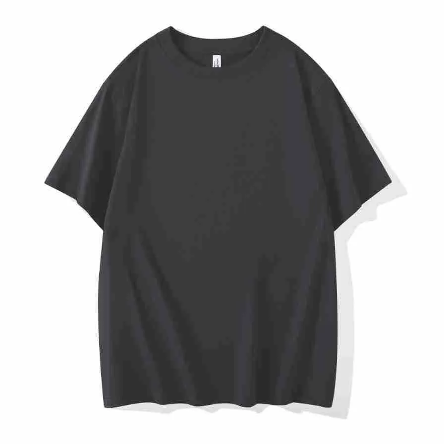 Man wearing a heavyweight dark grey drop shoulder T-shirt with layered shoulder detail.