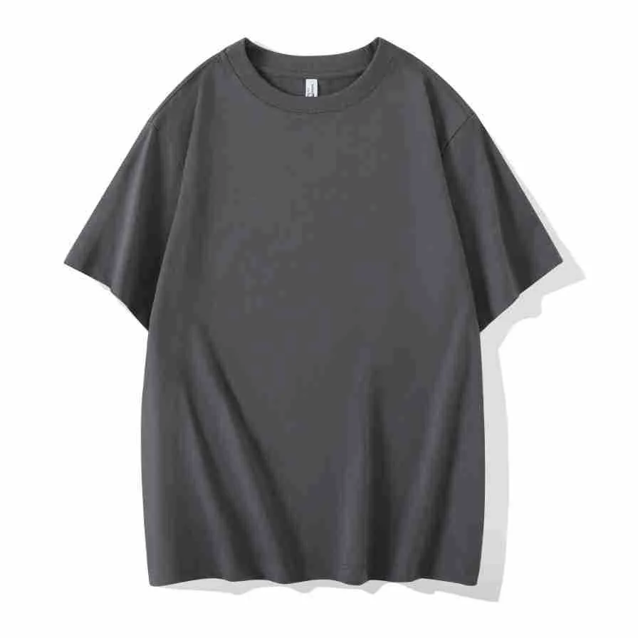 Man wearing a heavyweight dark grey drop shoulder T-shirt with layered shoulder detail.