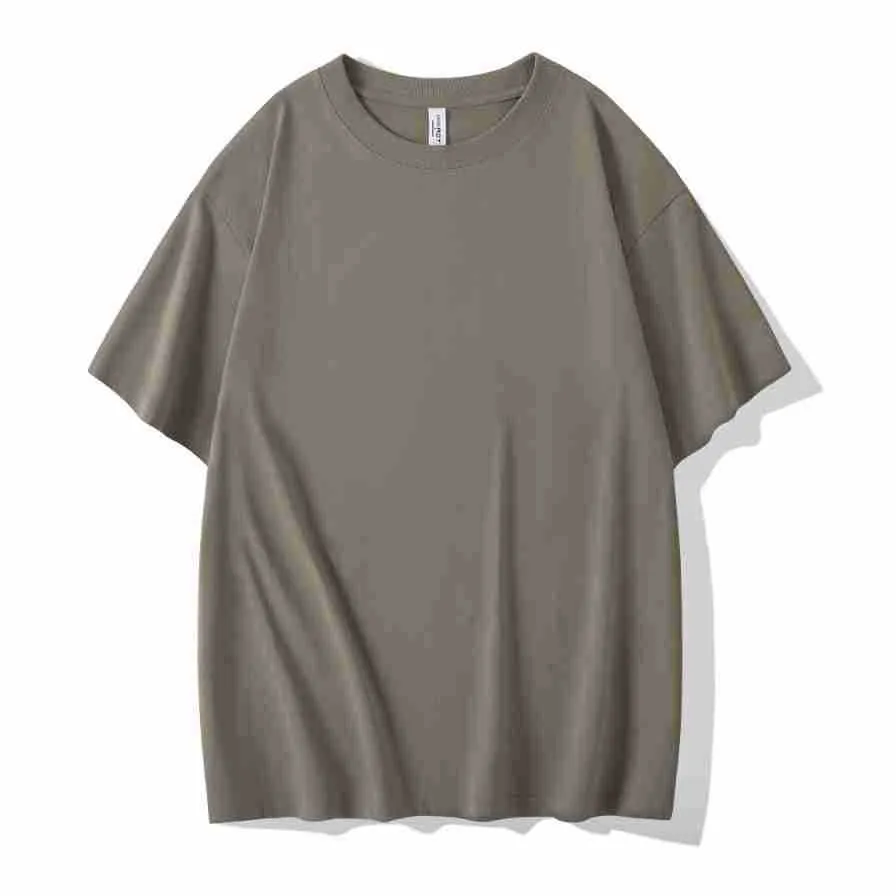 Man wearing a heavyweight dark grey drop shoulder T-shirt with layered shoulder detail.