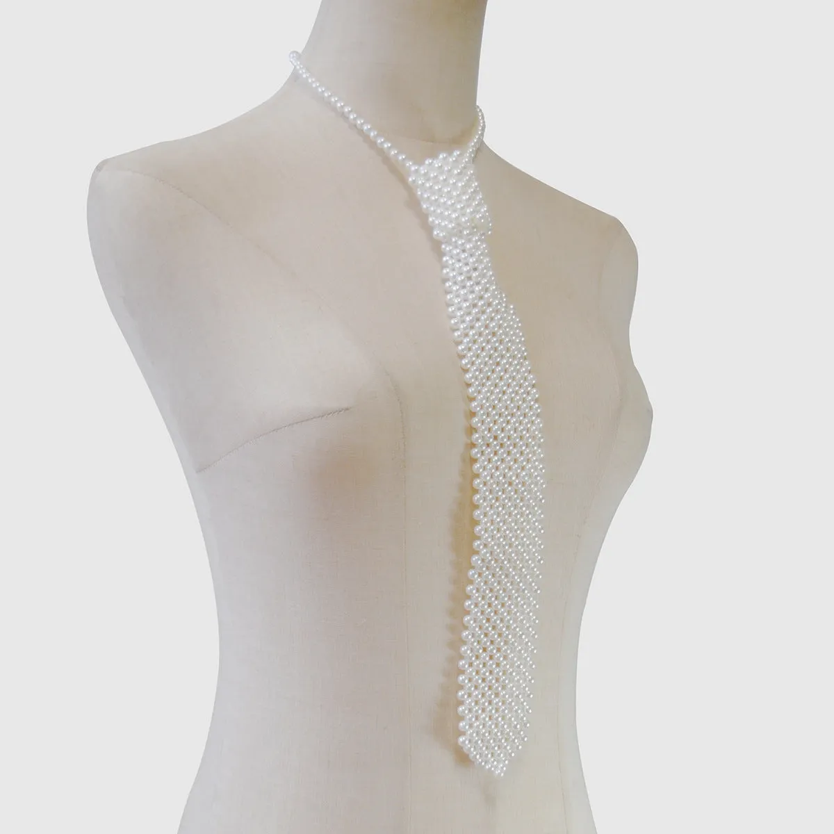 Women's pearl tie body chain with hollow out design and adjustable alloy closure in black or white colour