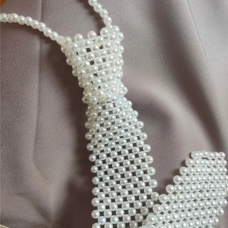 Women's pearl tie body chain with hollow out design and adjustable alloy closure in black or white colour